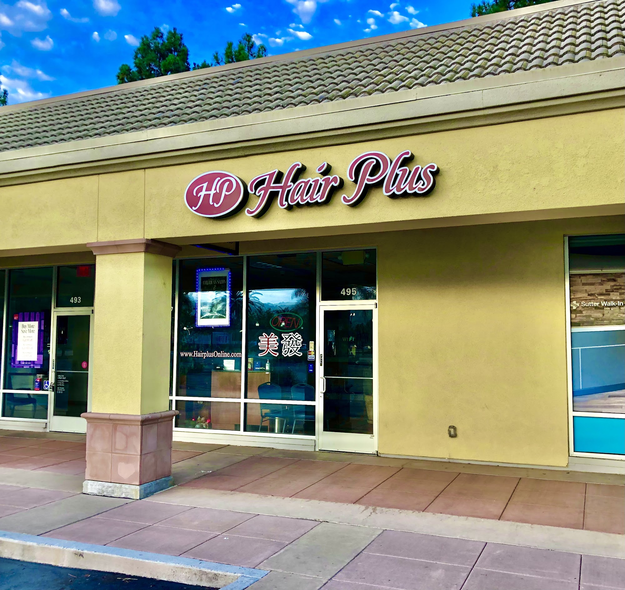 Hair Plus storefront at Milpitas Town Center, door number 495, pink Hair Plus sign